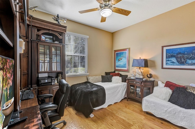 bedroom featuring light wood-type flooring and ceiling fan