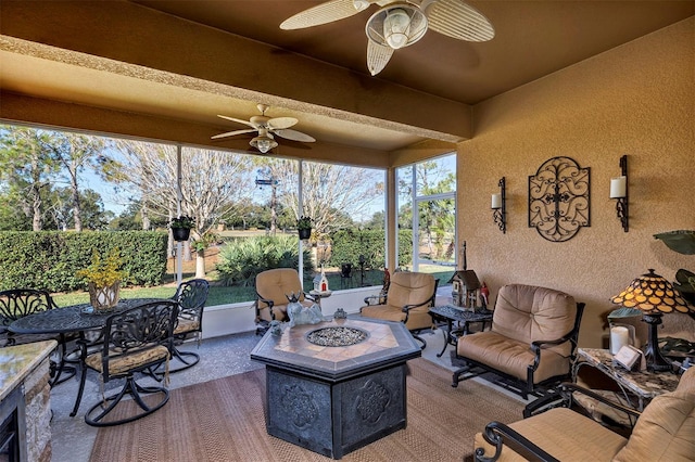 exterior space featuring ceiling fan and a fire pit