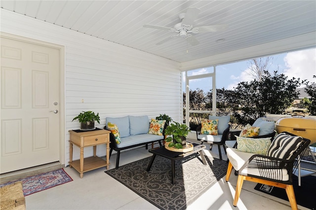 sunroom featuring ceiling fan