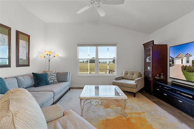 living room with ceiling fan, lofted ceiling, and light wood-type flooring