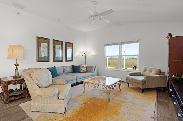 living room with ceiling fan, lofted ceiling, and hardwood / wood-style floors