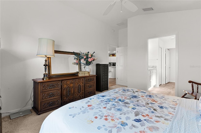 carpeted bedroom with ceiling fan, ensuite bath, and lofted ceiling