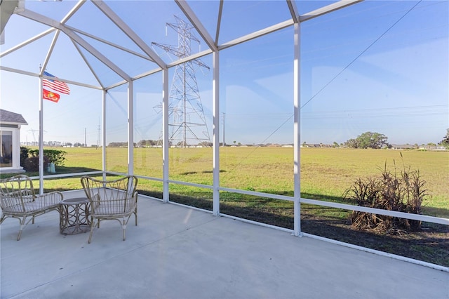 unfurnished sunroom featuring a rural view