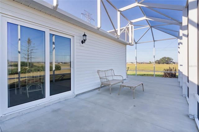 view of patio with glass enclosure