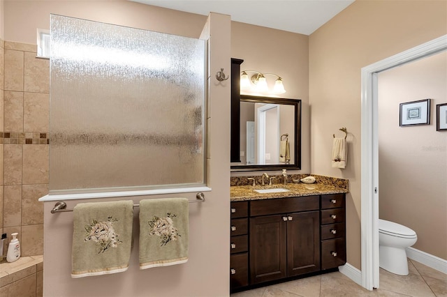 bathroom featuring toilet, vanity, and tile patterned floors