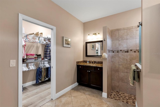 bathroom featuring tile patterned floors, vanity, and tiled shower