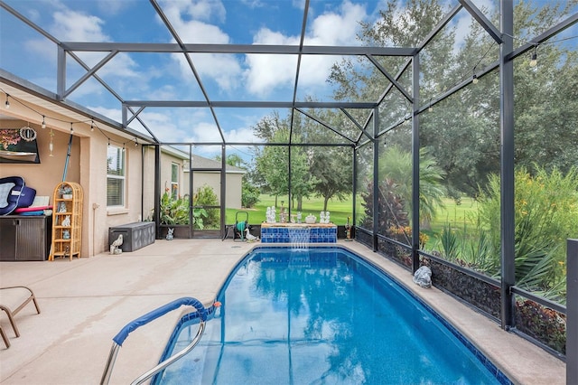 view of swimming pool featuring pool water feature, a lanai, and a patio