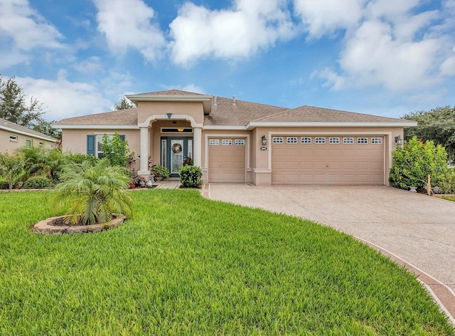 view of front of home featuring a garage and a front lawn