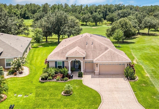 view of front of property featuring a garage and a front yard