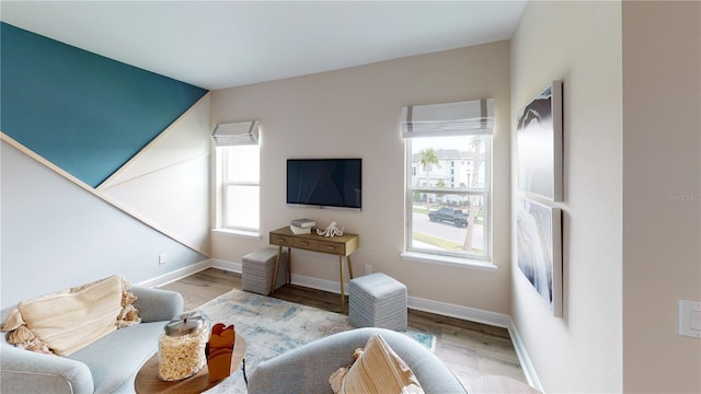 living room featuring wood-type flooring and vaulted ceiling