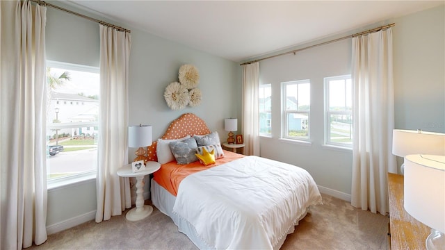 bedroom featuring light colored carpet