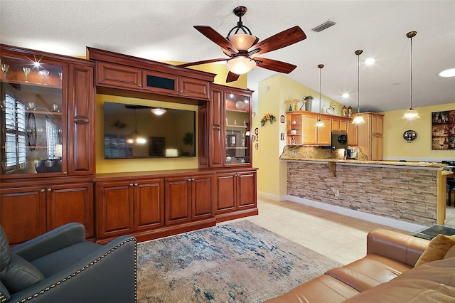 living room featuring vaulted ceiling and ceiling fan