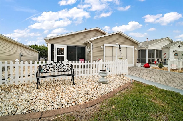 rear view of property with a garage