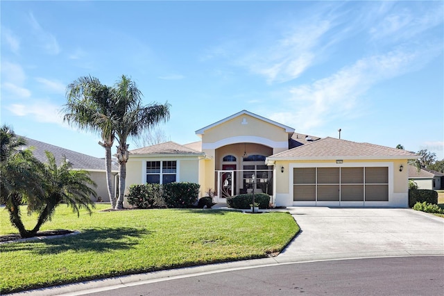 ranch-style house featuring a garage and a front lawn