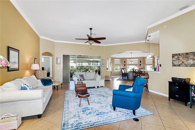 tiled living room with ceiling fan and ornamental molding