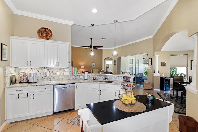 kitchen with dishwasher, sink, ceiling fan, white cabinetry, and decorative columns