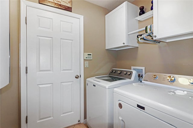 laundry area with cabinets and independent washer and dryer