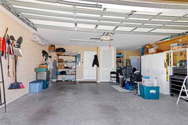 garage featuring electric panel and a garage door opener