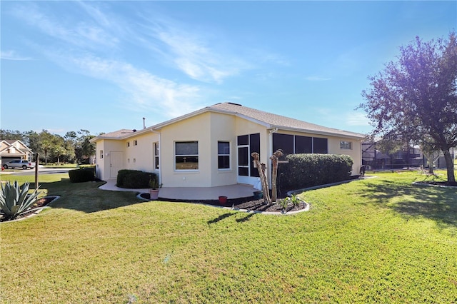 back of property with a lawn