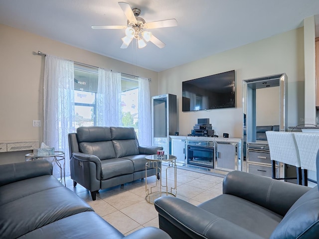 living room with ceiling fan and light tile patterned floors