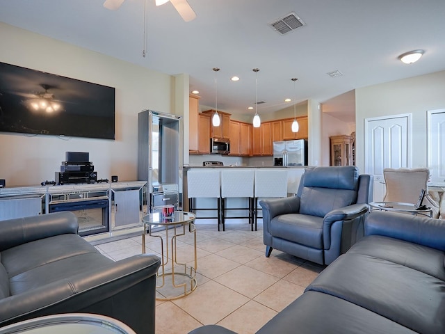 tiled living room featuring ceiling fan