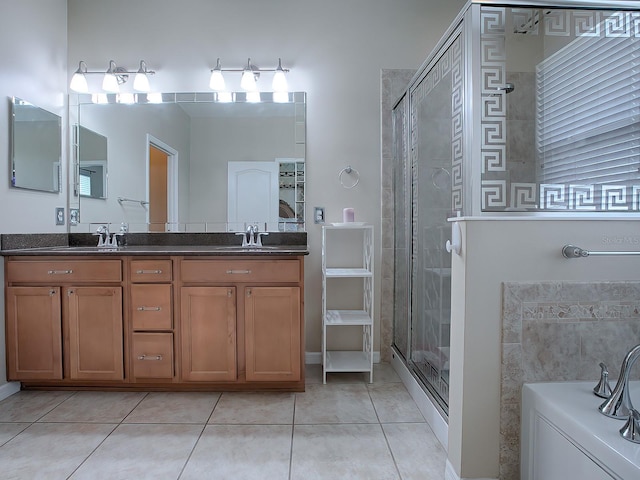 bathroom with vanity, tile patterned floors, and a shower with shower door