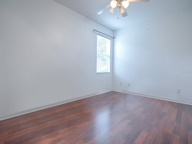 empty room featuring dark hardwood / wood-style flooring and ceiling fan