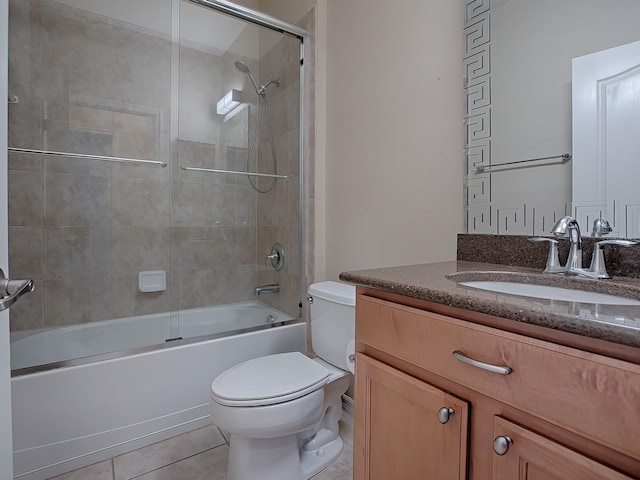 full bathroom featuring tile patterned flooring, vanity, toilet, and shower / bath combination with glass door