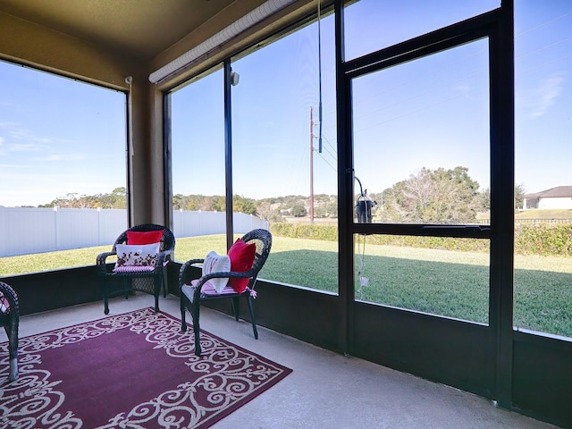 sunroom / solarium with a water view