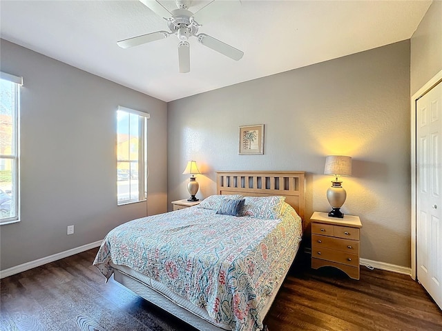 bedroom with dark hardwood / wood-style flooring, a closet, and ceiling fan