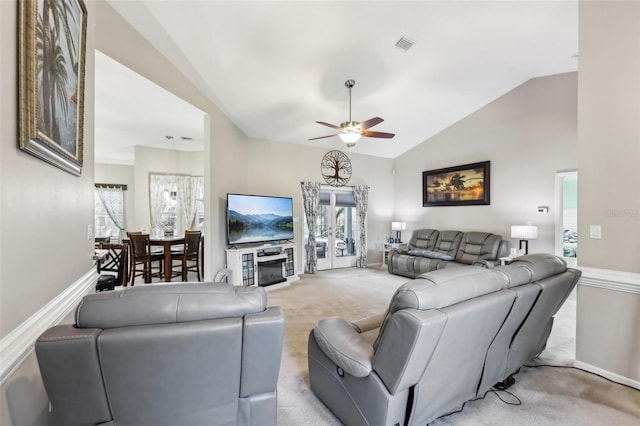 living room featuring ceiling fan, plenty of natural light, light colored carpet, and vaulted ceiling