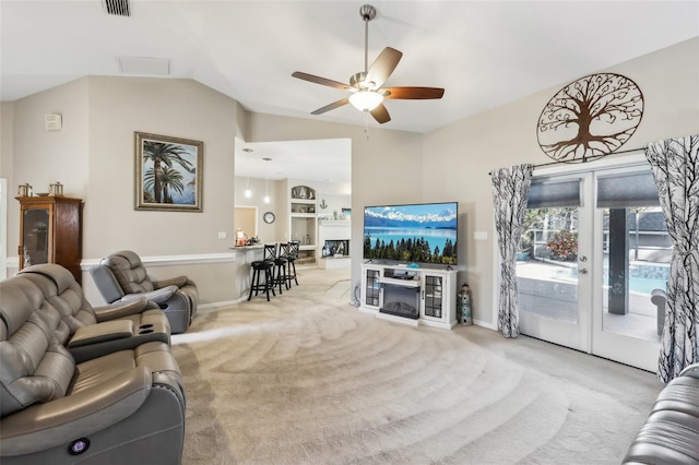 carpeted living room featuring vaulted ceiling and ceiling fan