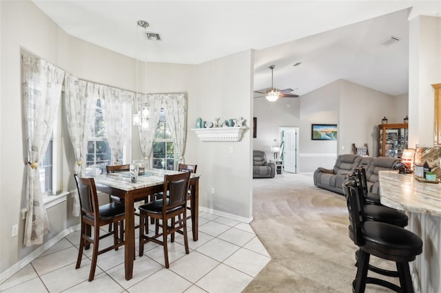 dining room with ceiling fan and light carpet