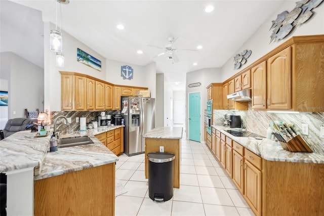 kitchen featuring sink, hanging light fixtures, tasteful backsplash, kitchen peninsula, and stainless steel appliances