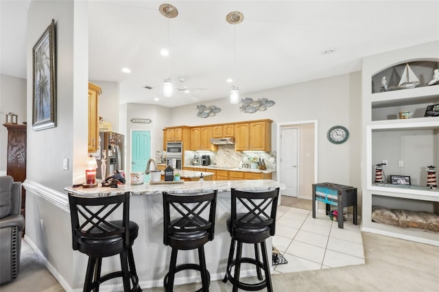 kitchen featuring stainless steel fridge with ice dispenser, built in features, backsplash, a breakfast bar area, and light tile patterned flooring