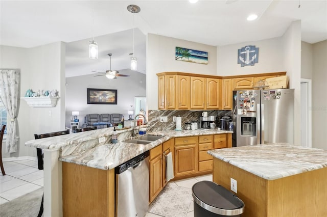 kitchen with kitchen peninsula, light tile patterned floors, stainless steel appliances, and sink