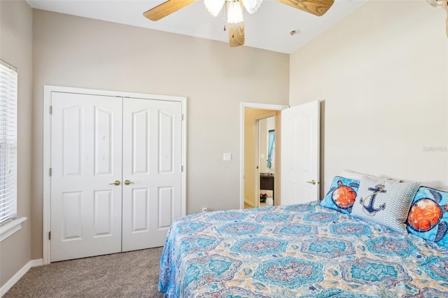 carpeted bedroom featuring ceiling fan and a closet