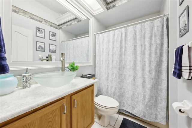 bathroom with tile patterned flooring, vanity, and toilet