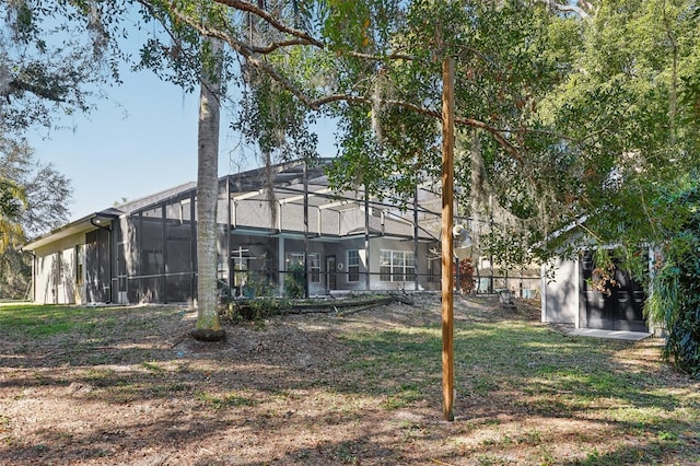 back of house featuring a lanai