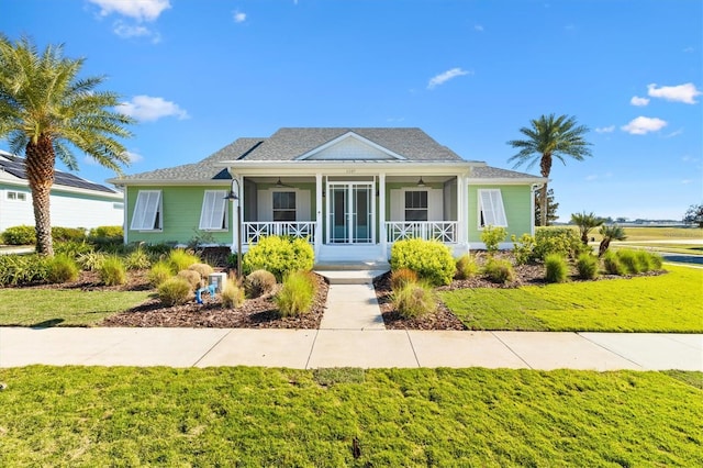 bungalow with a front lawn and ceiling fan