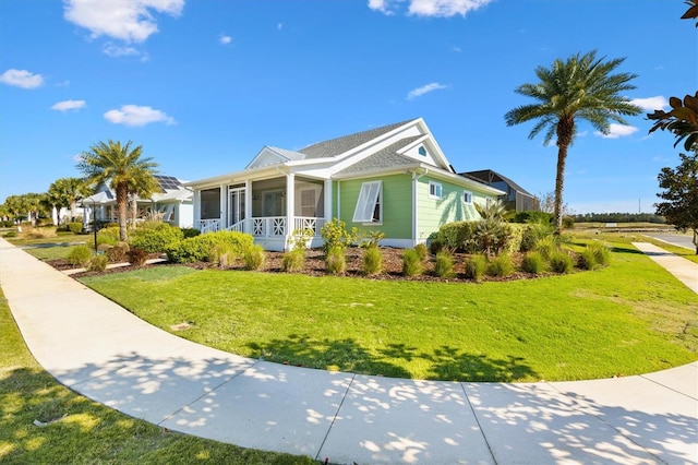 view of side of property featuring a yard and a sunroom