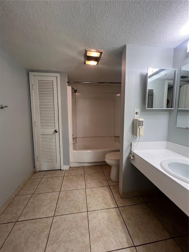 full bathroom with toilet, shower / bathing tub combination, tile patterned floors, and a textured ceiling