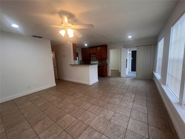 unfurnished living room featuring ceiling fan