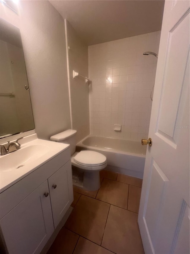 full bathroom with vanity, tile patterned flooring, toilet, and tiled shower / bath combo