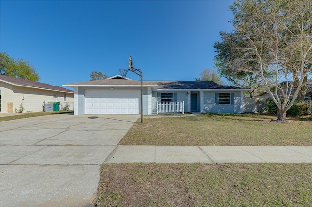 ranch-style home with a garage and a front lawn