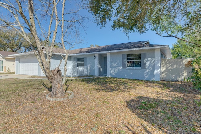 single story home featuring a front yard and a garage