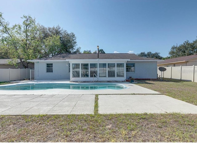 view of pool with a sunroom, a patio area, and a yard