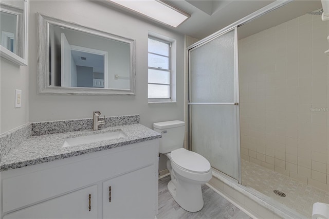 bathroom with vanity, toilet, and walk in shower