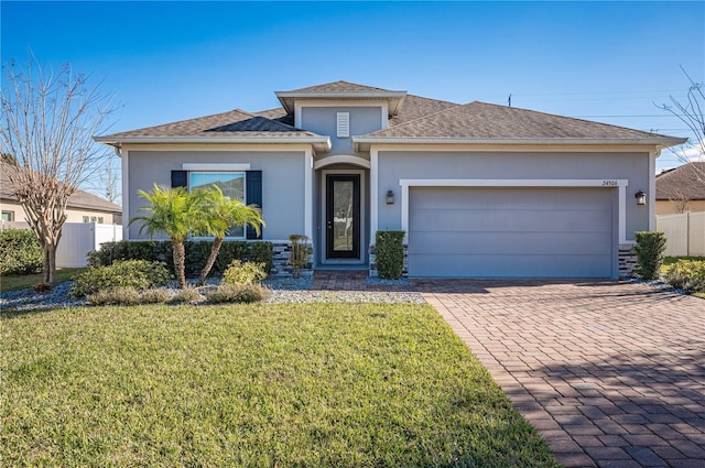 view of front of home with a front yard and a garage