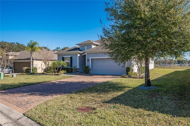 view of front of property with a garage and a front lawn